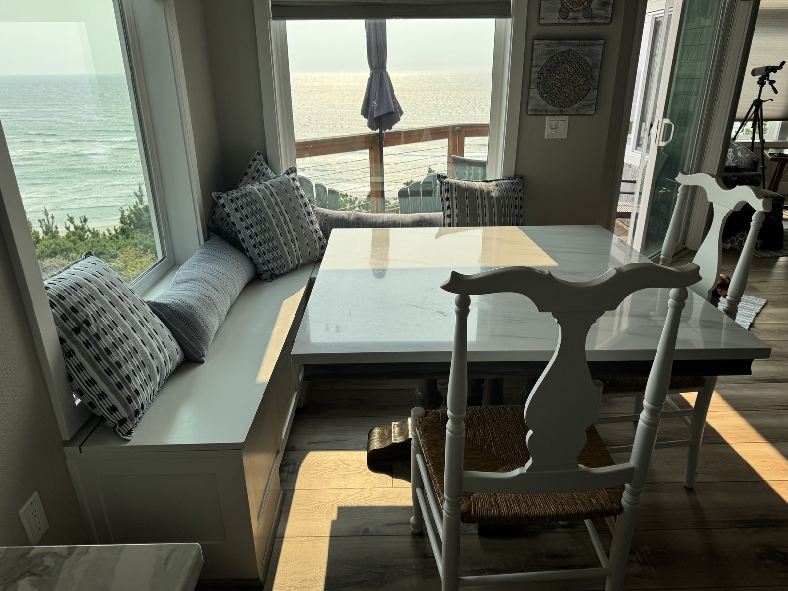 Completed L-shaped storage bench with dining table and ocean view