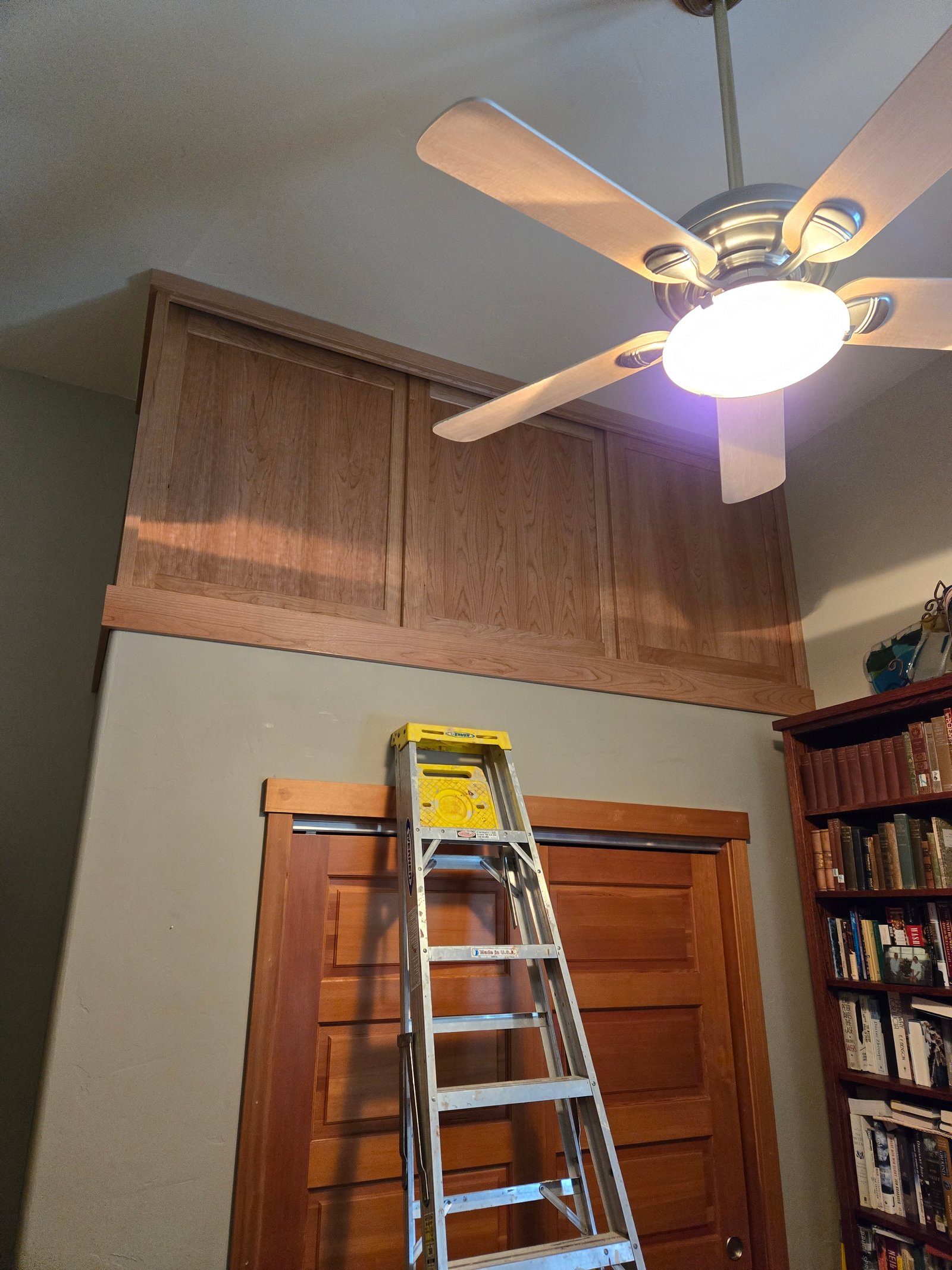 Rolling library ladder on brass rail