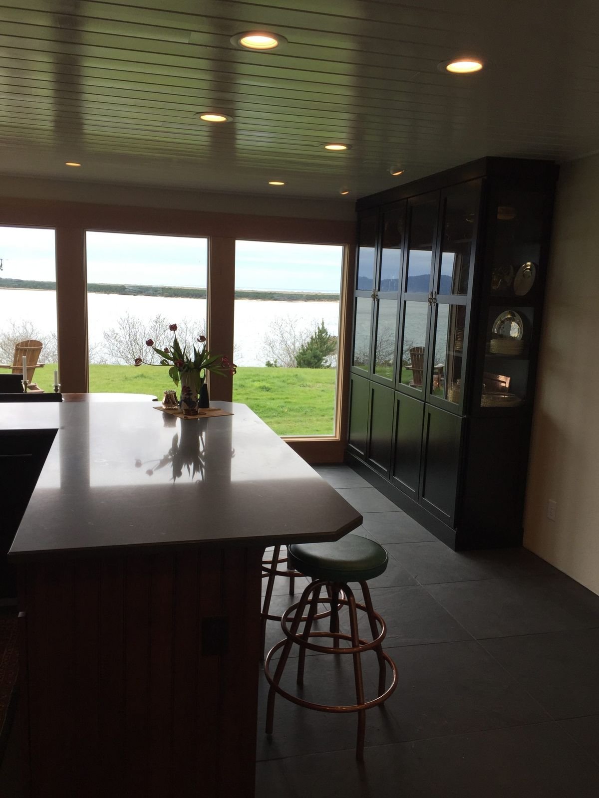 Finished kitchen with custom cabinets and large windows