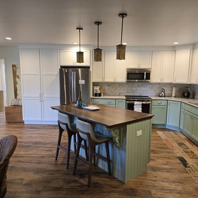 Casey Jay Winters Construction two-tone green and white kitchen remodel with walnut island top, Tillamook Oregon